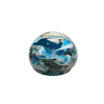 Glass marble with blue and white swirls on a gray background